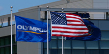 Olympus and US flag in front of office building